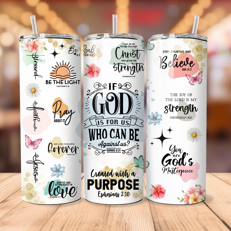May include: Three white tumblers with inspirational quotes and floral designs. The tumblers feature quotes such as "Be the Light", "If God is for us, who can be against us?", and "Stop doubting and believe".
