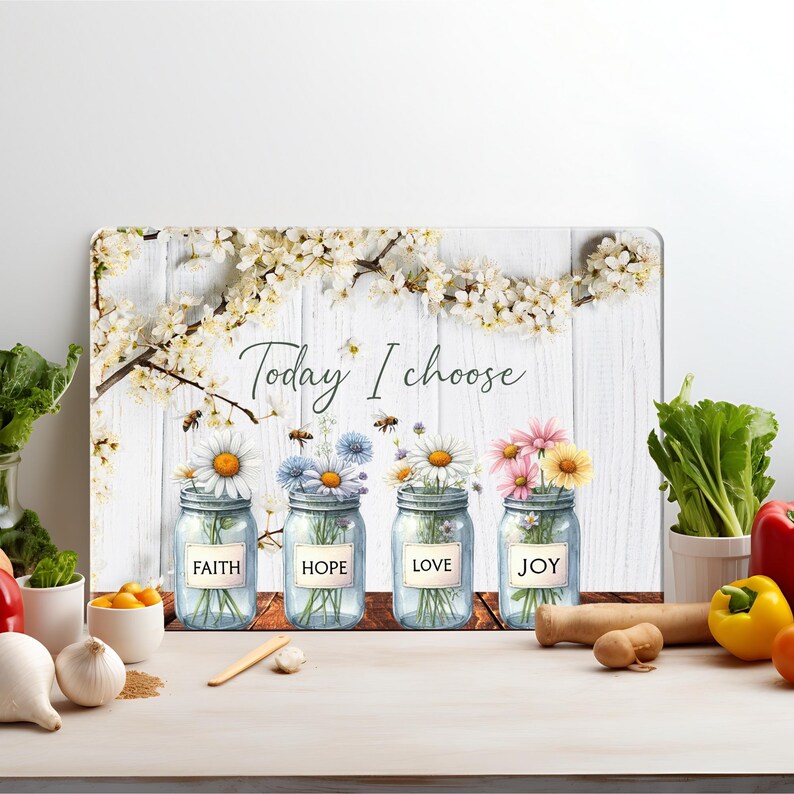 May include: A white wooden background with a floral design and four mason jars with the words "Faith", "Hope", "Love", and "Joy" on them. The text "Today I choose" is written above the jars.