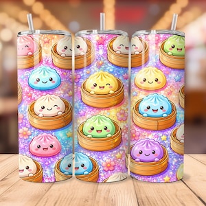 May include: A cylindrical tumbler with a straw featuring a repeating pattern of colorful, smiling bao buns in bamboo steamers against a sparkling, glittery background with small stars and pink cherry blossom flowers in various pastel shades.