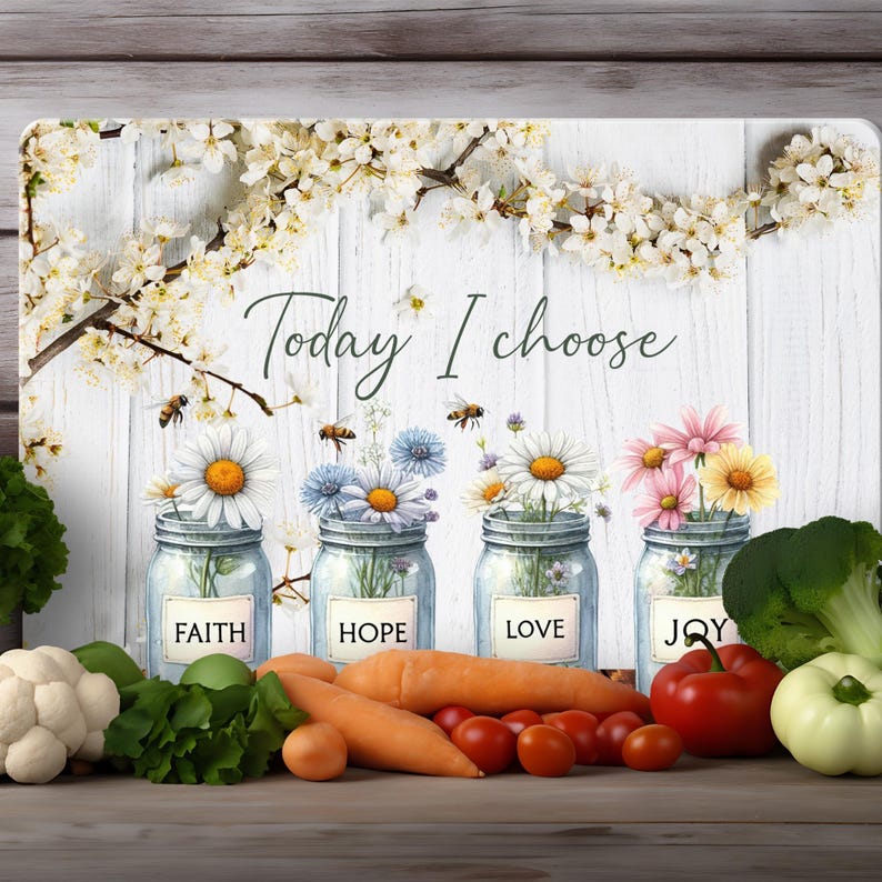 May include: White wooden sign with the text "Today I choose" and four mason jars with flowers and the words "Faith", "Hope", "Love", and "Joy" on them. The sign is surrounded by white flowers and green leaves.