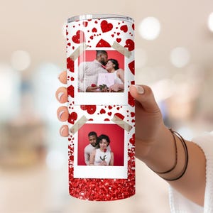 May include: A white tumbler with a red glitter background and a red heart pattern. Two photos are on the tumbler, one of a couple holding a bouquet of flowers and the other of a couple holding a single red rose.