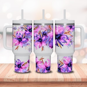 May include: Three white stainless steel tumblers with lids and straws. Each tumbler features a different floral design with pink and purple watercolor flowers.