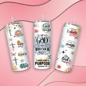 May include: Three white stainless steel tumblers with inspirational quotes and floral designs. The tumblers feature quotes such as "If God is for us, who can be against us?" and "You are God's masterpiece".