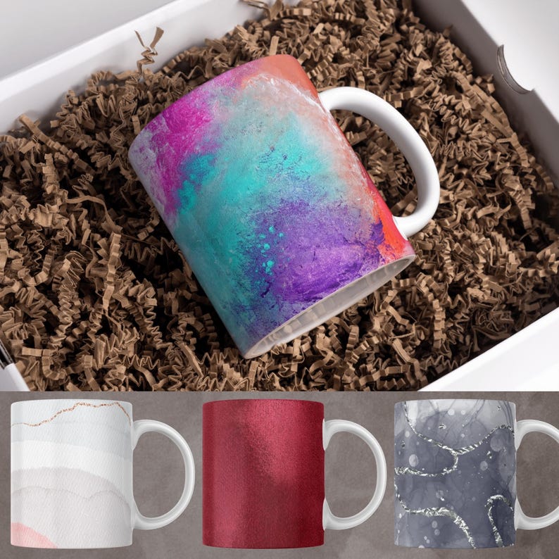 May include: Three different ceramic mugs with unique designs. The first mug has a colorful abstract design with shades of pink, purple, blue, and white. The second mug has a solid red color. The third mug has a gray and silver abstract design.