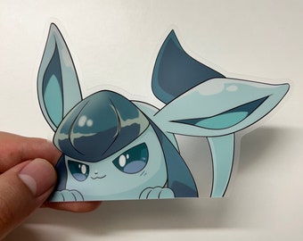 May include: A blue and white cartoon sticker of a Pokemon character, Eevee, with a surprised expression. The sticker is on a white background.