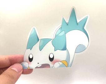 May include: A die-cut sticker depicting a cartoon creature with white fur, blue details, and rosy cheeks. The creature has large black eyes and is peeking out from the bottom of the sticker. The sticker is held by a hand.