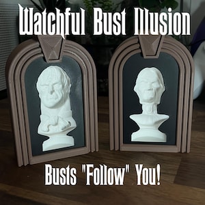 May include: Two white bust sculptures of men with serious expressions are displayed in ornate brown frames. The busts appear to follow the viewer as they move. The text "Watchful Bust Illusion" is above the frames and "Busts "Follow" You!" is below the frames.