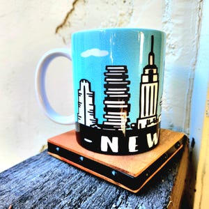 Hand Crafted New York City Skyline showing iconic buildings souvenir ceramic mug