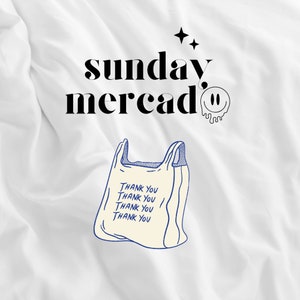 May include: White t-shirt with black text that says "sunday mercado" and a dripping smiley face. A blue and white illustration of a plastic bag with the text "Thank you" repeated four times is below the text.