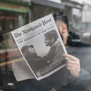 May include: A black and white newspaper headline announcing the wedding of Oliver and Ashley. The headline reads "The Newlywed Post" and "The Wedding of the Year".
