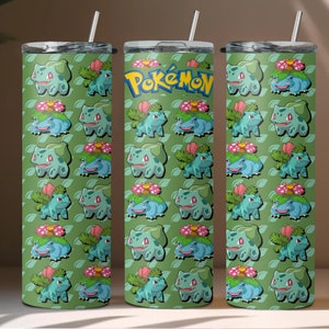 May include: Three stainless steel tumblers with a green background and a repeating pattern of a green and brown Pokemon character. The middle tumbler has the word "Pokemon" printed in white.