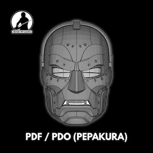 Puede incluir: Una máscara facial completa gris y segmentada con un diseño mecánico rígido, remaches visibles, una placa frontal prominente y una sección bucal rectangular. El texto "ARMORY OF LEGENDS" y "PDF / PDO (PEPAKURA)" es visible en la imagen.