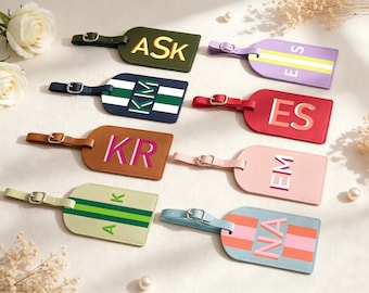 May include: Eight rectangular luggage tags with adjustable buckle straps, featuring various colors including olive, lavender, navy, red, tan, pink, light green, and light blue, each personalized with different letter monograms.