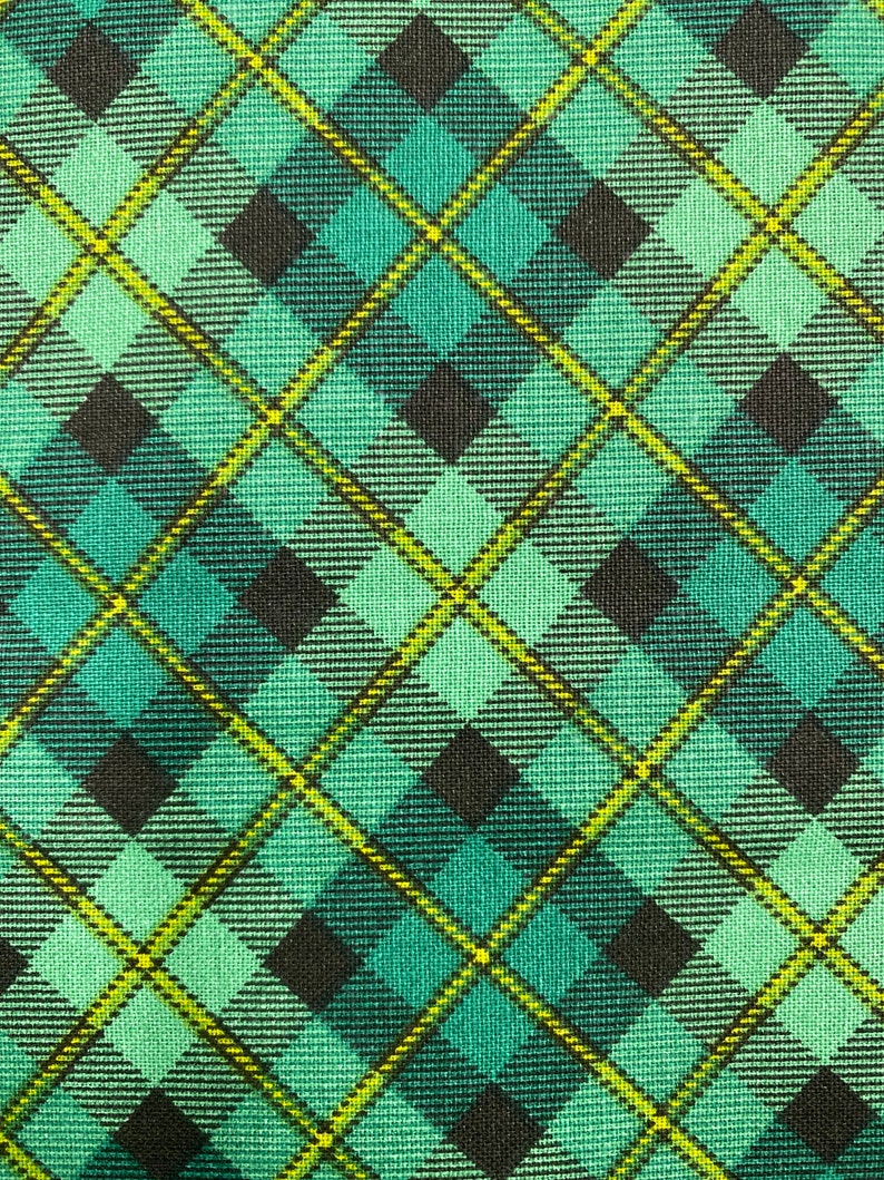 May include: A green and black plaid fabric with a yellow and white checkered pattern.