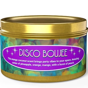 May include: A gold tin candle with a purple label that says "*DISCO BOUJEE*+". The label has a colorful background with a pattern of overlapping circles. The text on the label reads "This mango coconut scent brings party vibes to your space. Amazing notes of pineapple, orange, mango, with a burst of peach."