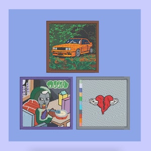 May include: Three framed embroidered patches. The first patch features a cartoon of a person wearing a green helmet and eating cereal. The second patch features a colourful striped design. The third patch features a broken heart with crossed bones.