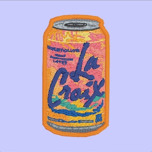 May include: A colorful embroidered patch of a La Croix sparkling water can. The can is orange, yellow, pink, blue, and green. The text on the can reads "La Croix".