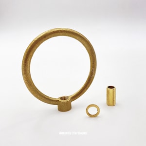 May include: A brass ring with a threaded base, a brass threaded pipe, and a brass washer. Amanda Hardware is printed below the image.