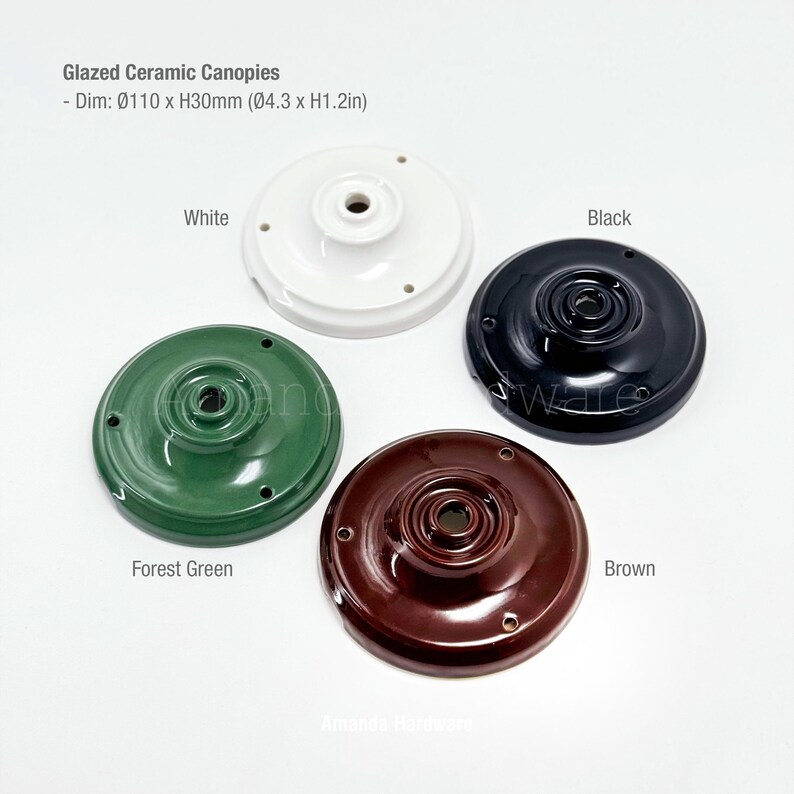 May include: Four glazed ceramic canopies in white, black, forest green, and brown. Each canopy is round, with a central hole and three smaller holes. Dimensions are &Oslash;4.3 inches x 1.2 inches.