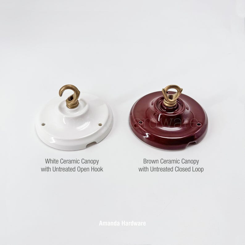 May include: Two ceramic ceiling canopies. One is white with an untreated open hook, and the other is brown with an untreated closed loop. The text on the image reads "Amanda Hardware."