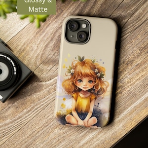 May include: A beige phone case with a glossy finish features a cartoon illustration of a fairy with brown hair, wearing a yellow shirt and sitting on a flower. The fairy has large blue eyes and a sweet expression. The case has a camera cutout with three lenses.