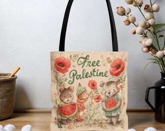 May include: Beige tote bag with black handles featuring a watercolor illustration. The illustration includes the text "Free Palestine" in green script, surrounded by red poppies and cartoon animals holding watermelon slices.
