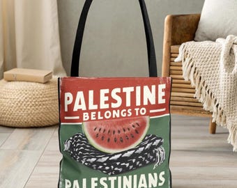 May include: A red, white, and green tote bag with the text "Palestine belongs to Palestinians" and a watermelon on top of a black and white striped fabric.