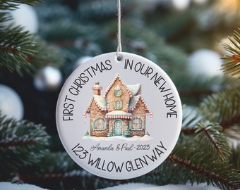 May include: White ceramic Christmas bauble featuring a gingerbread house illustration. The text reads "First Christmas in our new home" and "123 Willow Glen Way".