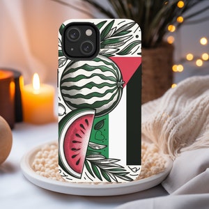 May include: A white phone case with a green and red watermelon design. The case has a black border and a white background with a green leaf design. The watermelon is cut in half and the inside is red.