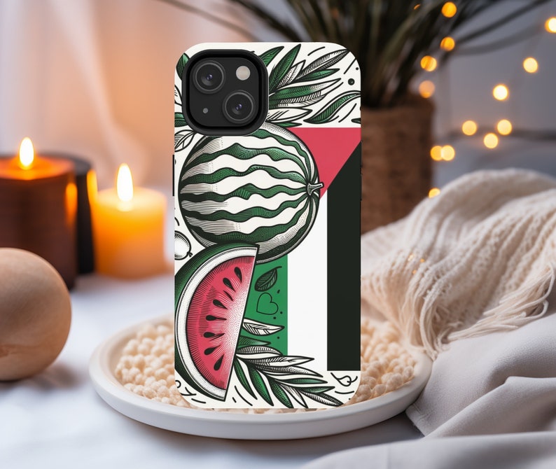 May include: A white phone case with a green and red watermelon design. The case has a black border and a white background with a green leaf design. The watermelon is cut in half and the inside is red.