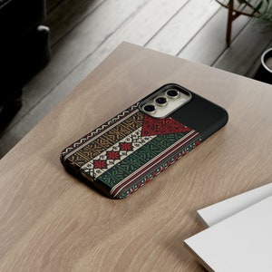 May include: A phone case with a colorful geometric pattern and a black border. The case has a camera cutout and a raised lip around the edges.