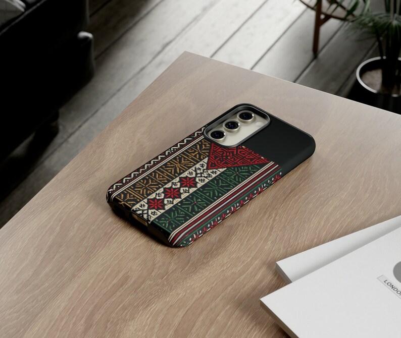May include: A phone case with a colorful geometric pattern and a black border. The case has a camera cutout and a raised lip around the edges.