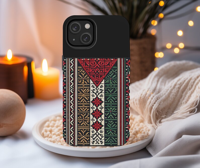 May include: A black phone case with a colorful geometric pattern. The pattern features red, green, white, and black colors. The case has a cutout for the phone's camera.