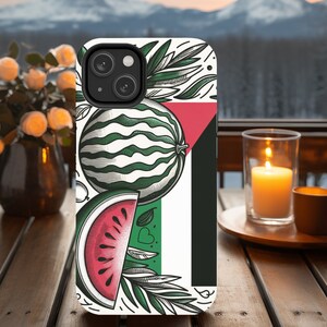 May include: A white phone case with a green, white, and red watermelon design. The case has a black camera lens cutout and a white background.