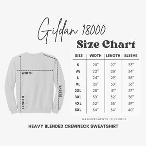 May include: Size chart for Gildan 18000 heavy blended crewneck sweatshirt. The chart shows measurements in inches for width, length, and sleeve length for sizes S through 5XL.