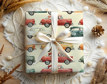 May include: A white gift box with a vintage car pattern. The box is tied with a white satin ribbon and bow. The cars are red, yellow, green, and blue.