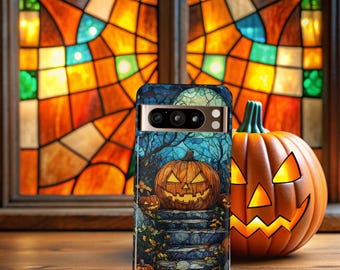 May include: A smartphone case with a Halloween-themed design featuring a carved pumpkin on a stone staircase, with a full moon and trees in the background. A carved pumpkin sits to the right. The background includes a stained glass window.