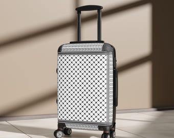 May include: A black and white patterned suitcase with a retractable handle and four wheels. The suitcase has a geometric design with black and white squares and circles.