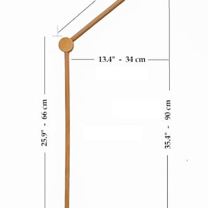 May include: Wooden baby mobile stand with a cloud-shaped base. The stand is 25.9 inches tall and 13.4 inches wide. The arm is 16.9 inches long.