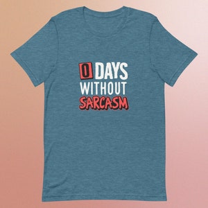 May include: A blue t-shirt with the text "0 DAYS WITHOUT SARCASM" in white and red.