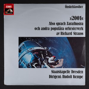May include: A vintage vinyl record album cover with the text "2001" and "Also sprach Zarathustra" by Richard Strauss. The cover features a space-themed image with a spacecraft and an astronaut. The album is from EMI.