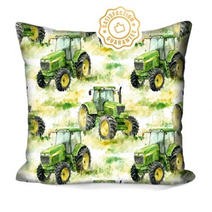 May include: A white pillowcase with a repeating pattern of green tractors on a watercolour background. The tractors are green and have black wheels. The background is a watercolour wash of green and yellow.