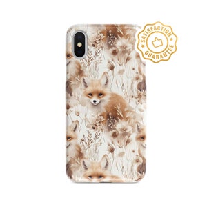May include: A white phone case with a pattern of brown foxes and flowers. The case has a cut-out for the camera lens and a gold sticker that says "Satisfaction Guarantee".