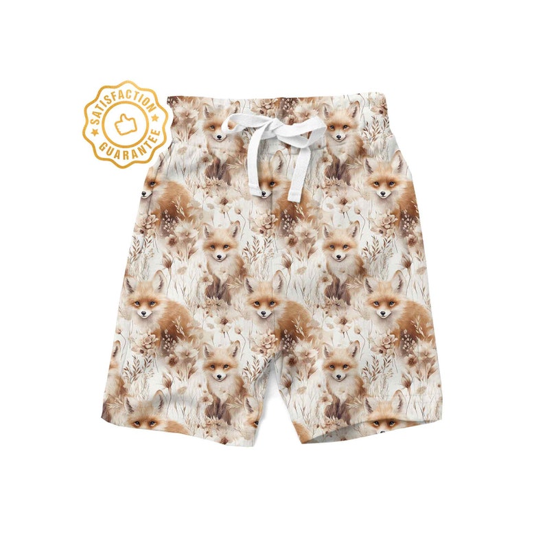 May include: White shorts with a repeating pattern of brown foxes and beige foliage. The shorts have a white drawstring.