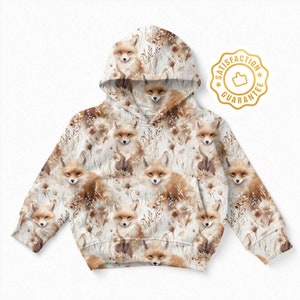 May include: A white hooded sweatshirt with a repeating pattern of brown foxes and brown foliage. The sweatshirt has a drawstring hood and long sleeves.