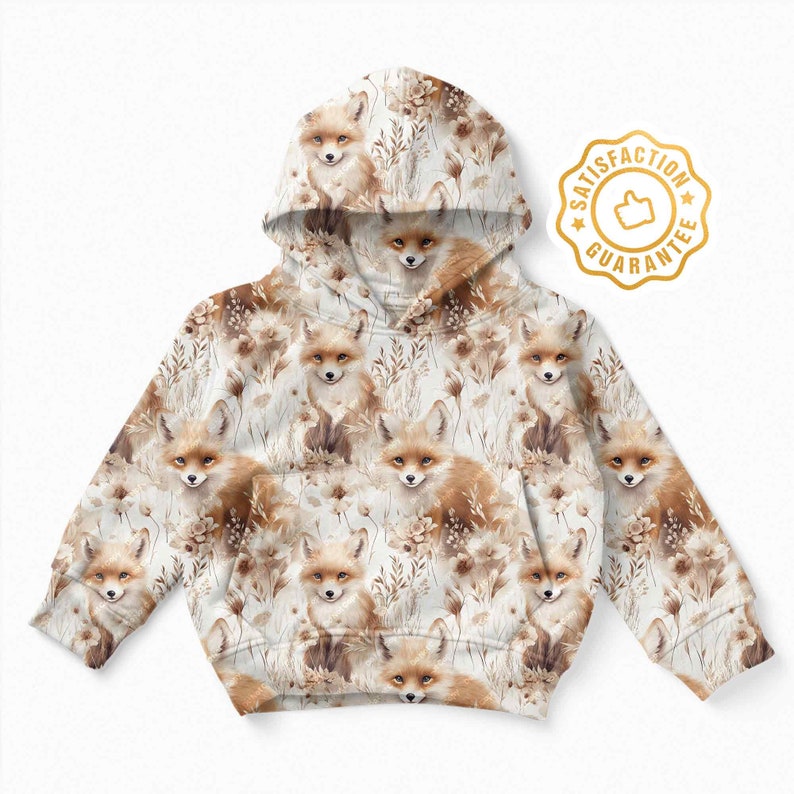 May include: A white hooded sweatshirt with a repeating pattern of brown foxes and brown foliage. The sweatshirt has a drawstring hood and long sleeves.