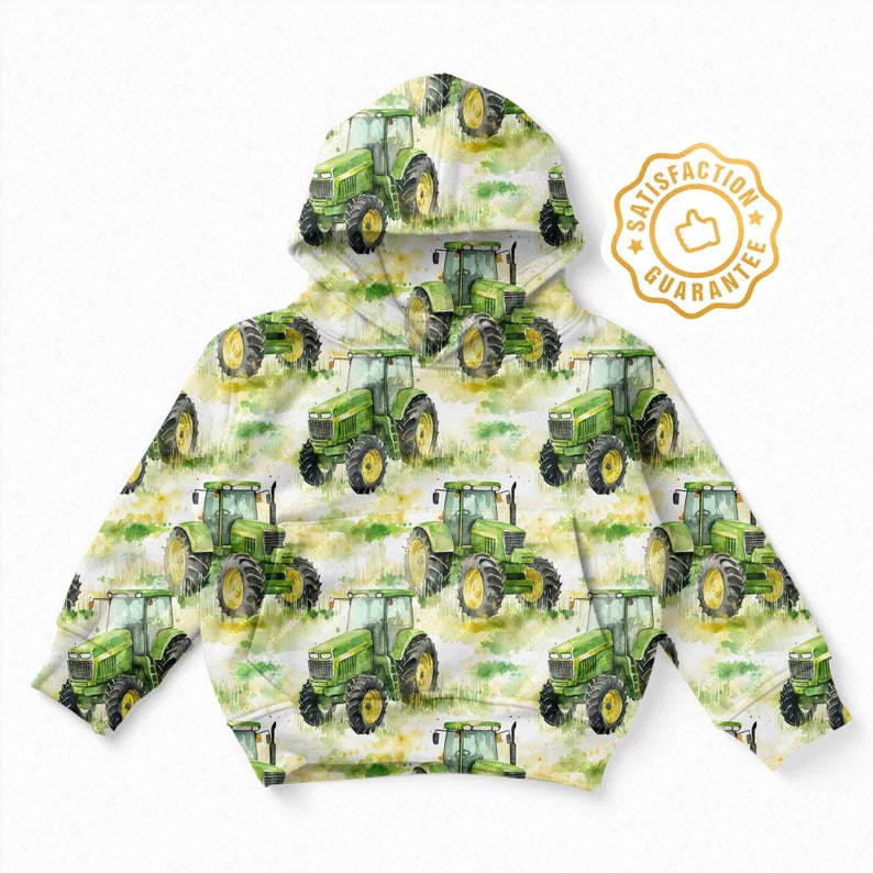 May include: A white hooded sweatshirt with a green and yellow watercolour pattern of tractors. The sweatshirt has a gold satisfaction guarantee label with a thumbs up icon.