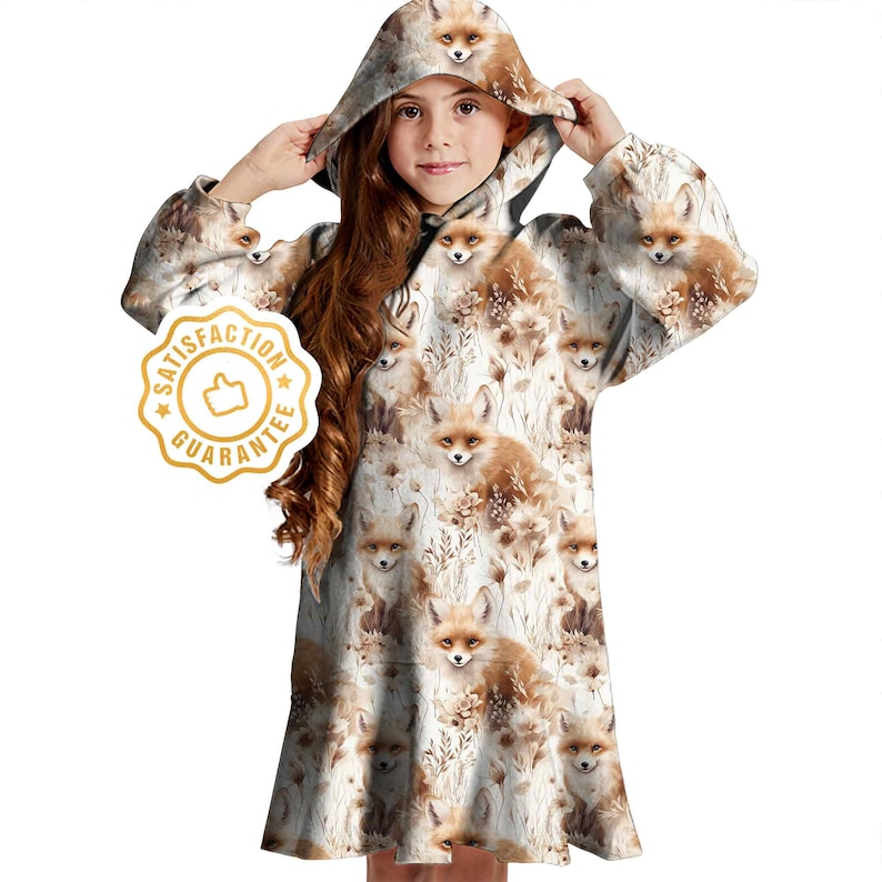 May include: A white hooded dress with a fox print. The dress has long sleeves and a loose fit. The hood is lined with a brown fabric. The dress has a brown and white fox print all over. The dress has a white background with brown foxes and flowers.