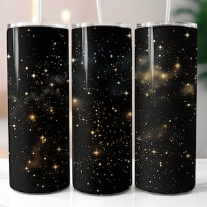 May include: Three stainless steel tumblers with a black background and gold glitter stars. The tumblers are lined up in a row.