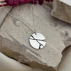 May include: A set of three ceramic nesting bowls in shades of blue, green, and white. The bowls feature a speckled glaze and a simple, modern design. The largest bowl is approximately 7 inches in diameter.